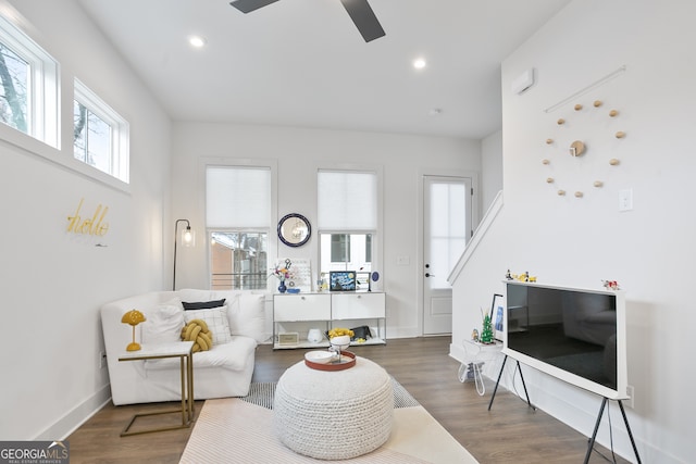 living room with dark hardwood / wood-style floors and ceiling fan