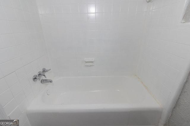 bathroom featuring a tub to relax in