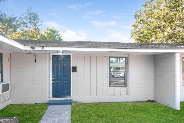 entrance to property with a lawn