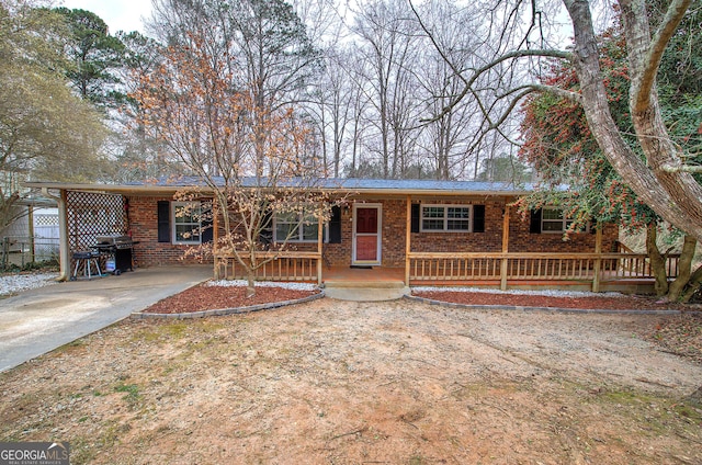 single story home with a porch and brick siding