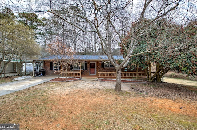 ranch-style home with covered porch and brick siding