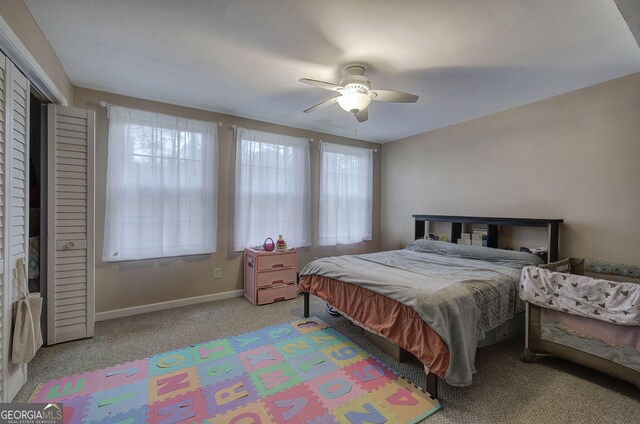 bedroom with ceiling fan, light hardwood / wood-style flooring, and a closet