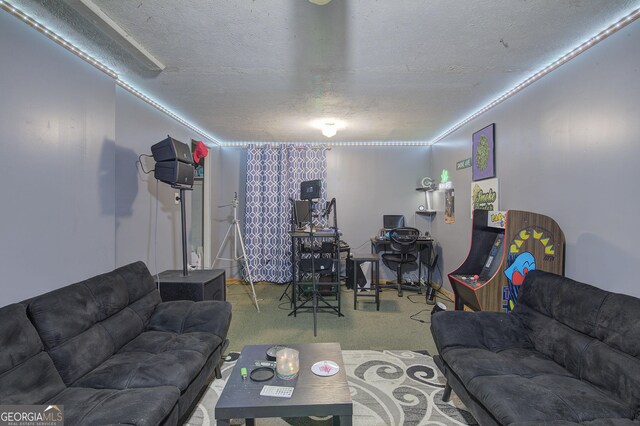 home theater room featuring dark carpet and a textured ceiling