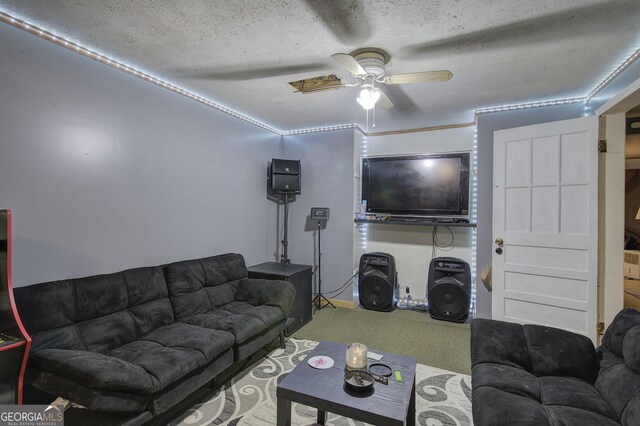 living area featuring a textured ceiling, carpet, and a ceiling fan