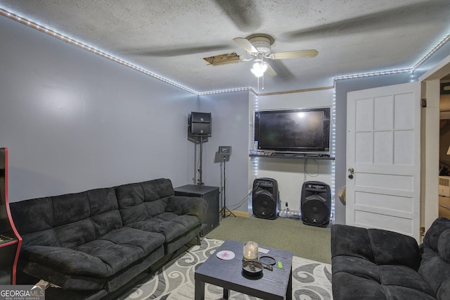 living room featuring ceiling fan, a textured ceiling, and carpet floors