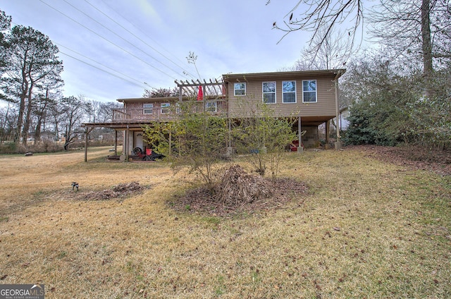 back of house with stairs, a deck, a carport, and a yard