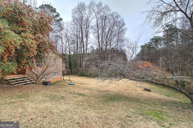 view of yard featuring a deck and central AC