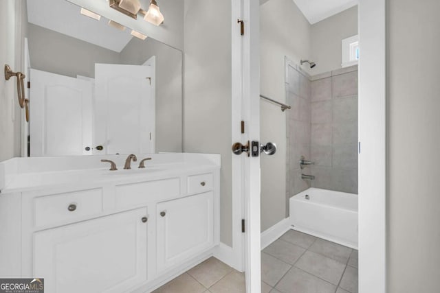 bathroom with tile patterned floors, vanity, and tiled shower / bath combo