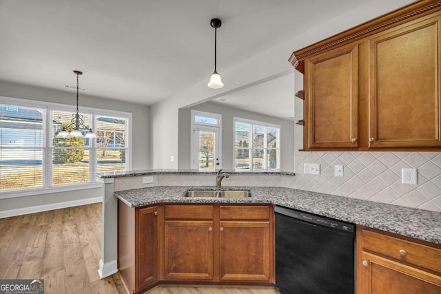 kitchen with dishwasher, light hardwood / wood-style floors, kitchen peninsula, sink, and light stone countertops