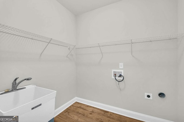 laundry room featuring sink, electric dryer hookup, hookup for a washing machine, and hardwood / wood-style flooring