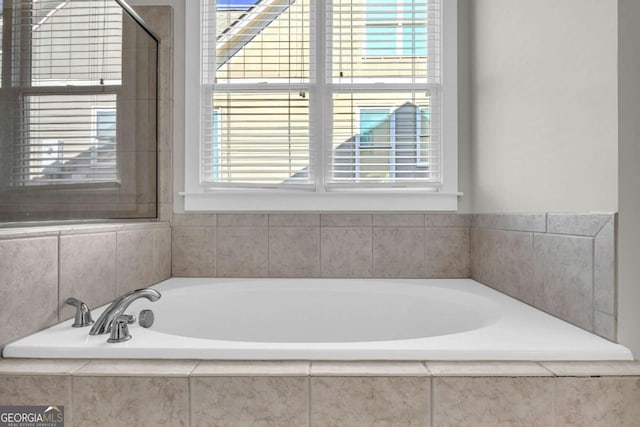 bathroom with tiled tub