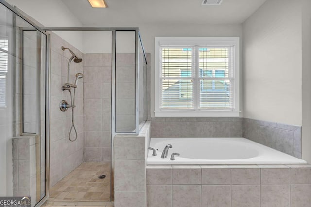 bathroom with separate shower and tub