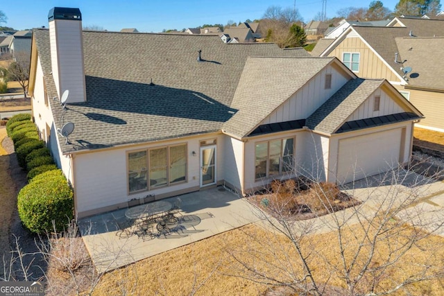 view of front of house with a patio area and a garage