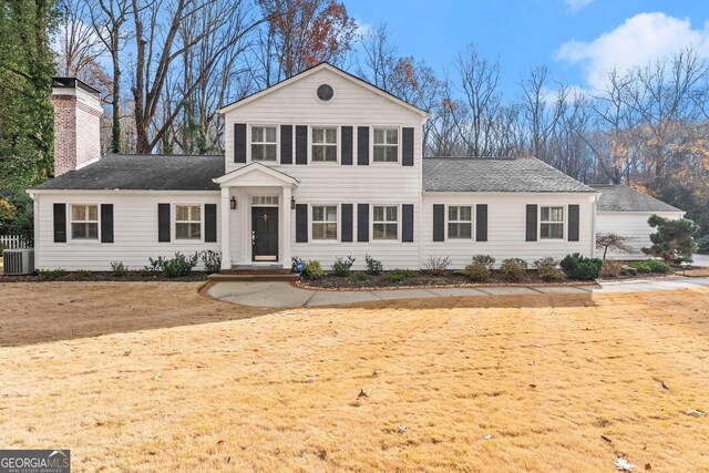 front of property featuring a front yard and central AC