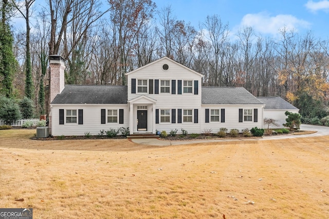 front of property featuring a front yard and central AC unit