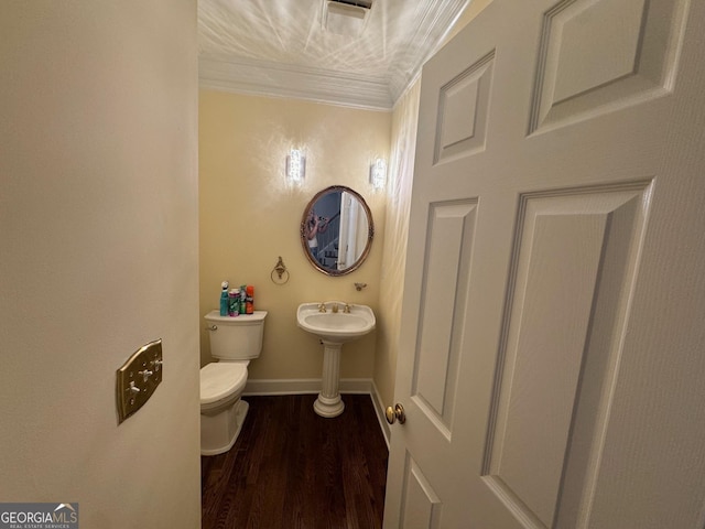 bathroom with crown molding, wood-type flooring, and toilet