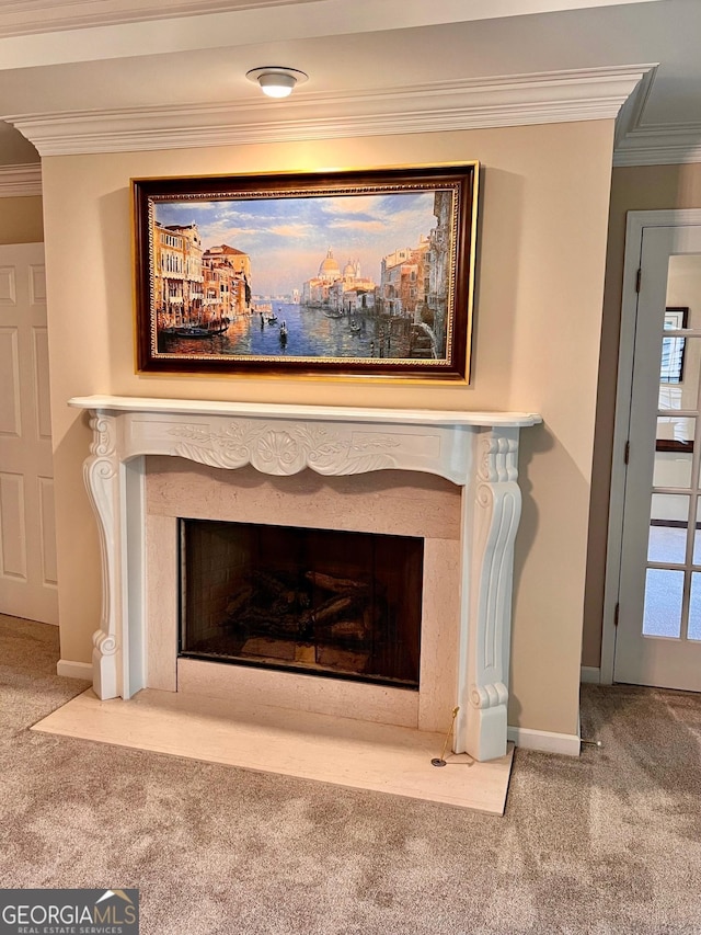 details featuring a high end fireplace, carpet floors, and ornamental molding