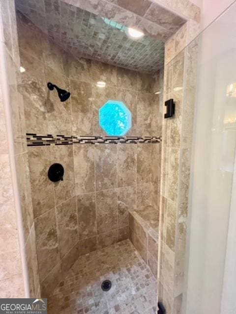 bathroom with a tile shower