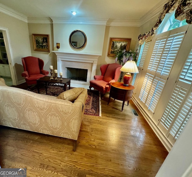 living room featuring hardwood / wood-style flooring and crown molding