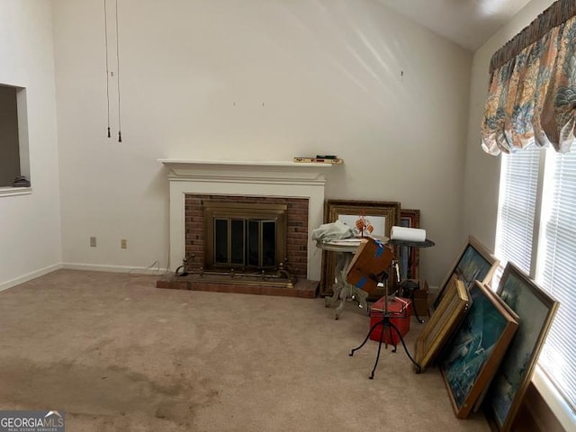 carpeted living room with a brick fireplace