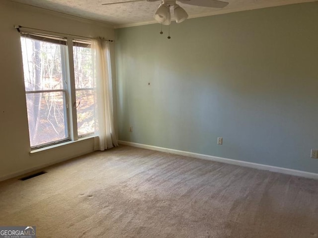 unfurnished room featuring carpet flooring, ceiling fan, and a textured ceiling