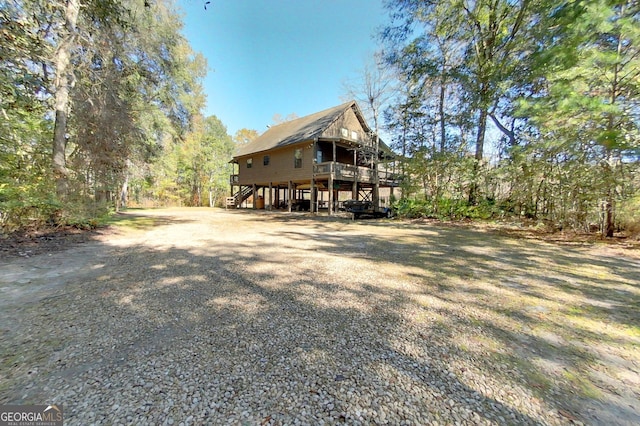 view of front of home with a wooden deck and a carport