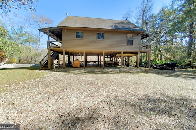 rear view of property with a carport