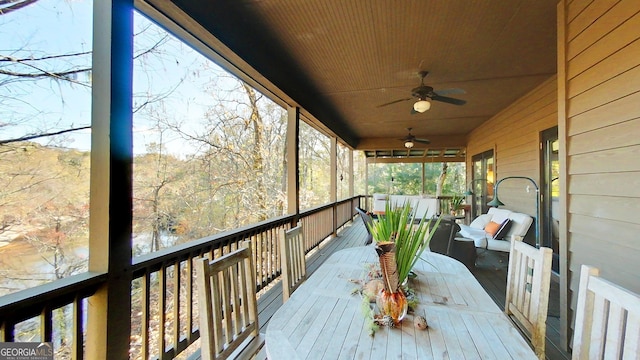 sunroom with ceiling fan and wood ceiling