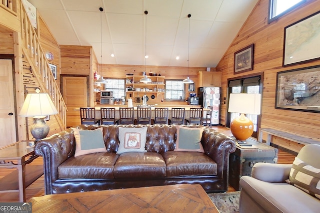 living room with wooden walls and vaulted ceiling