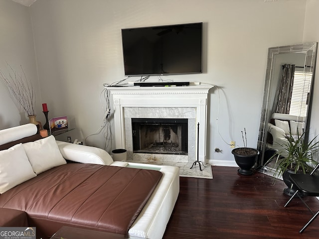 bedroom with a fireplace and dark wood-type flooring