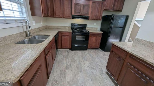 kitchen featuring light stone counters, sink, black appliances, light hardwood / wood-style flooring, and range hood