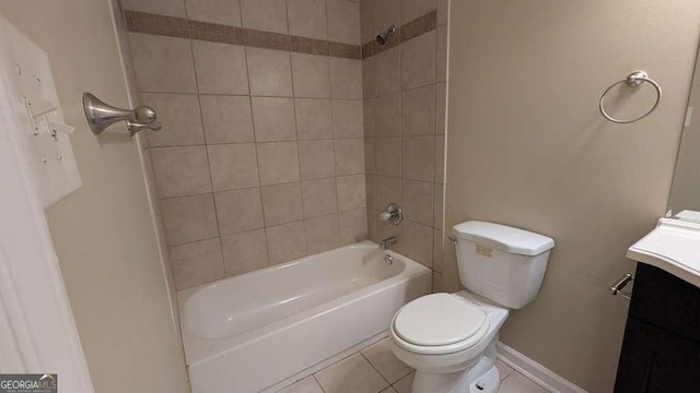 full bathroom with tiled shower / bath, tile patterned flooring, vanity, and toilet