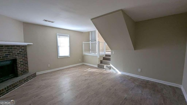 unfurnished living room with hardwood / wood-style flooring and a fireplace