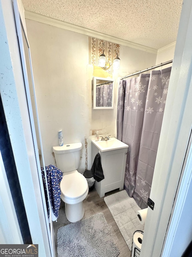 bathroom with sink, crown molding, wood-type flooring, a textured ceiling, and toilet