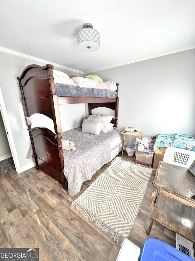 bedroom featuring dark wood-type flooring and ornamental molding