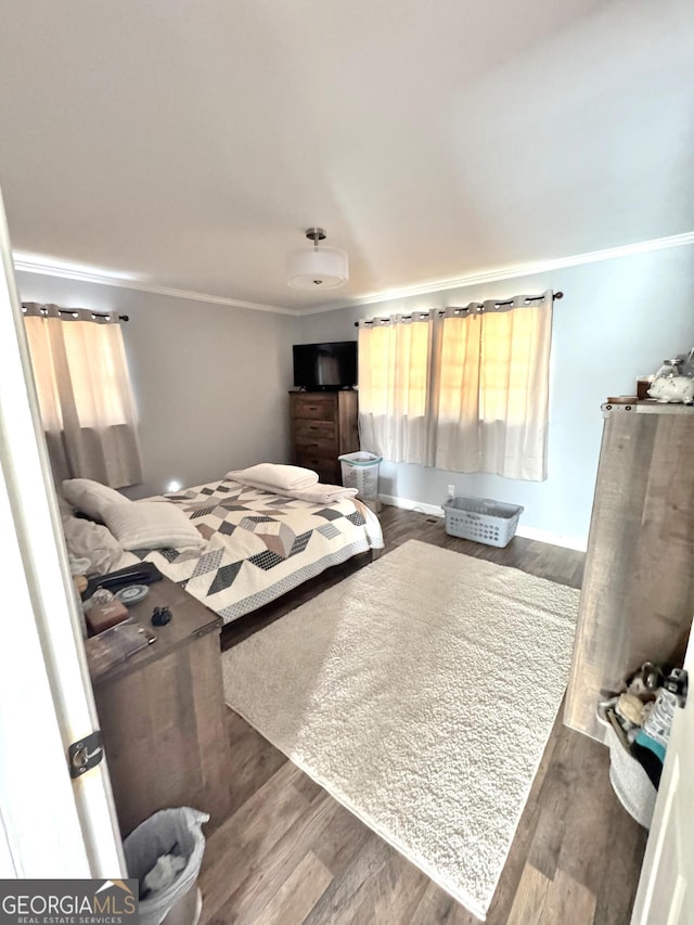 bedroom featuring multiple windows, crown molding, and dark hardwood / wood-style flooring