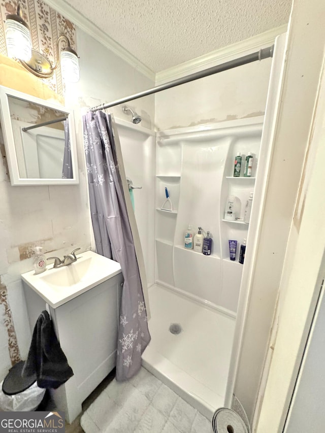 bathroom with a textured ceiling, vanity, curtained shower, and ornamental molding