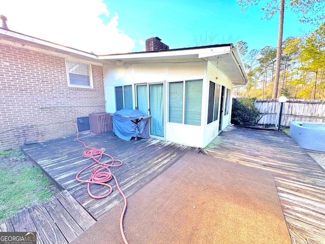 wooden deck with a sunroom