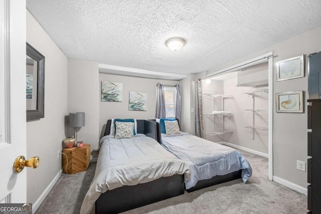 bedroom with a textured ceiling and carpet floors