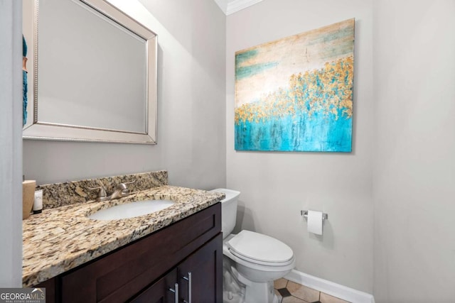 bathroom featuring tile patterned floors, crown molding, vanity, and toilet