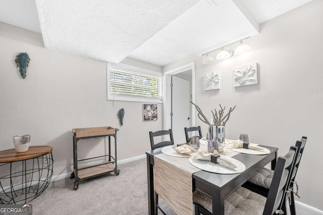 dining space featuring carpet and a textured ceiling