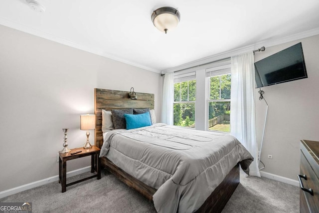 bedroom with crown molding and light carpet