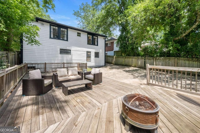 wooden deck with an outdoor living space with a fire pit