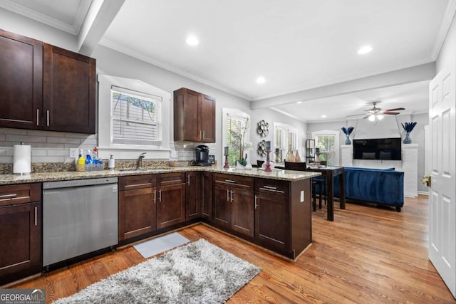 kitchen featuring dishwasher, light wood-type flooring, kitchen peninsula, and sink