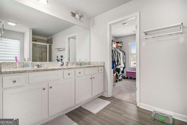 bathroom featuring vanity, hardwood / wood-style flooring, and walk in shower