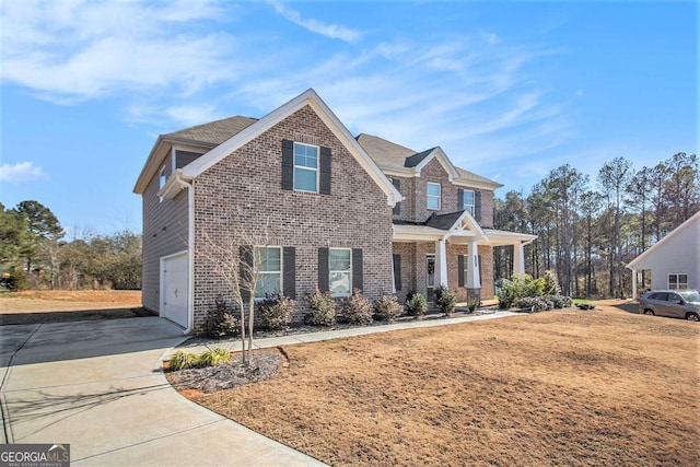 view of front of property with covered porch, a front lawn, and a garage