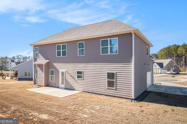 back of property with a yard and a patio area