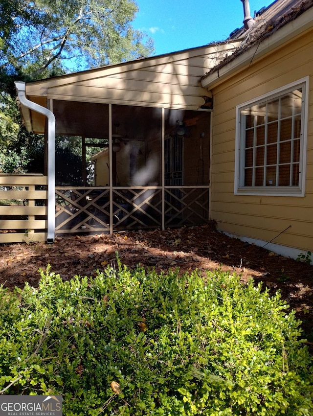 view of side of home featuring a sunroom