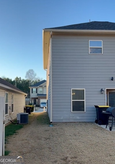 rear view of property with cooling unit