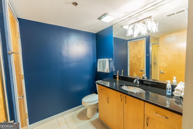 full bathroom featuring visible vents, toilet, a shower with shower door, vanity, and tile patterned flooring